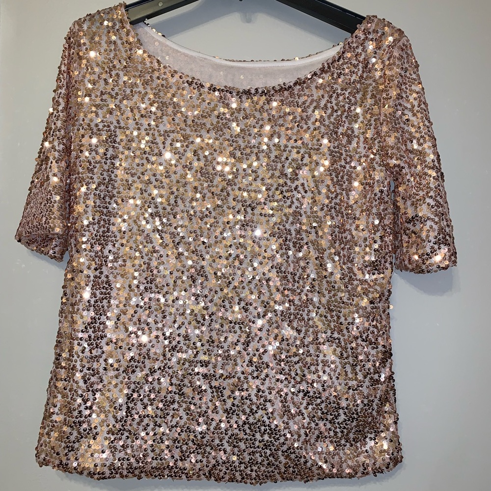 Loose fit boat neck or off shoulder sequin top. Fully lined